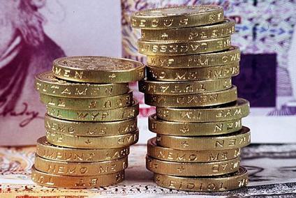 Pound coin stacks represent that successful websites earn businesses money